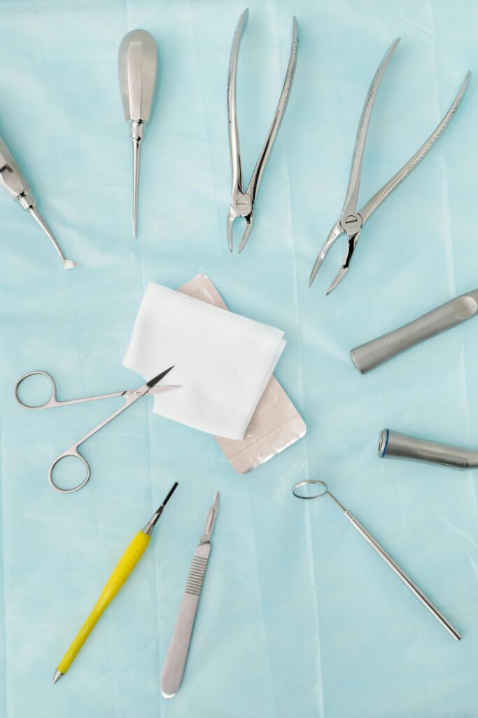 pexels photo 4269355 4269355 Top view of assorted dental surgical instruments on a blue background, sterile and ready for use.